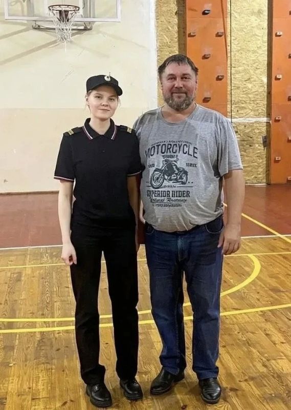 В День учителя полицейский Ксения поздравляет своего школьного наставника - директора школы Болонкина Артура Владимировича.